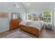 Bright bedroom featuring a vaulted ceiling, ample natural light, and warm wood furnishings at 100 Sydney Smt, Villa Rica, GA 30180