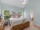 Sunlit bedroom boasting wood floors, a ceiling fan, and a view of the outdoors at 100 Sydney Smt, Villa Rica, GA 30180