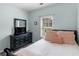 Bedroom with dark wooden dresser and mounted television at 100 Sydney Smt, Villa Rica, GA 30180