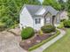 Charming home features a manicured lawn, stone accents, and a spacious driveway at 100 Sydney Smt, Villa Rica, GA 30180