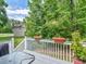 Relaxing deck area, perfect for outdoor entertaining, with potted plants and grill in the backyard at 100 Sydney Smt, Villa Rica, GA 30180