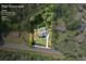 Aerial view showcasing the home's setting on a 1-acre lot, surrounded by lush greenery and mature trees at 10350 Alvin Rd, Johns Creek, GA 30022