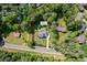 Aerial view of a home in Johns Creek with 1-acre lot surrounded by mature trees and landscaping at 10350 Alvin Rd, Johns Creek, GA 30022