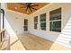 Covered porch with ceiling fan, wooden floors, and lots of natural light at 10350 Alvin Rd, Johns Creek, GA 30022