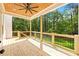 Wooden back porch, ceiling fan, and view of lush greenery at 10350 Alvin Rd, Johns Creek, GA 30022