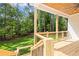 Elevated porch with wooden railing and lush greenery at 10350 Alvin Rd, Johns Creek, GA 30022