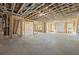 A large unfinished basement featuring framed walls, windows, and a staircase, ready for customization at 10350 Alvin Rd, Johns Creek, GA 30022