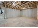 Unfinished basement with concrete walls and flooring, and exposed insulation with utilities at 10350 Alvin Rd, Johns Creek, GA 30022