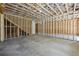 An unfinished basement with exposed framing, insulation, and concrete flooring, ready to be customized at 10350 Alvin Rd, Johns Creek, GA 30022
