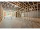 Spacious unfinished basement with concrete floor and framed walls, offering potential for future living space at 10350 Alvin Rd, Johns Creek, GA 30022