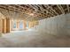 Unfinished basement with framed walls, concrete flooring, and windows, offering potential for customization at 10350 Alvin Rd, Johns Creek, GA 30022