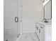 Bathroom featuring a glass shower, white vanity, and marble floors at 10350 Alvin Rd, Johns Creek, GA 30022