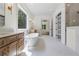 A luxury bathroom features marble floors, standalone tub, walk-in closet and shower at 10350 Alvin Rd, Johns Creek, GA 30022
