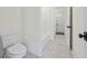 A clean and bright bathroom featuring marble flooring and a white toilet and shower tub combo at 10350 Alvin Rd, Johns Creek, GA 30022