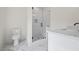 Modern bathroom featuring a glass shower and sleek vanity with marble countertops at 10350 Alvin Rd, Johns Creek, GA 30022