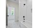 Bright white bathroom with tiled shower, black hardware, and marble floors at 10350 Alvin Rd, Johns Creek, GA 30022