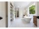 Bright bathroom features marble floors, standalone tub, walk-in closet and shower at 10350 Alvin Rd, Johns Creek, GA 30022