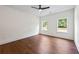 Bright bedroom with hardwood floors, a ceiling fan, and windows with a green view at 10350 Alvin Rd, Johns Creek, GA 30022