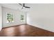 Bright bedroom featuring hardwood floors, ceiling fan, and windows at 10350 Alvin Rd, Johns Creek, GA 30022