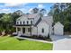 Stunning exterior of a two-story home with an attached garage, fresh landscaping, and a long driveway at 10350 Alvin Rd, Johns Creek, GA 30022