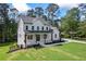 Elegant two-story home boasting a covered front porch, dark window trim, and lush green lawn at 10350 Alvin Rd, Johns Creek, GA 30022