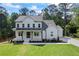 Charming two-story home featuring a welcoming front porch with wooden beams and professionally landscaped front yard at 10350 Alvin Rd, Johns Creek, GA 30022