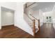 Bright foyer features hardwood floors, staircase with wood and white balusters, and entry to other rooms at 10350 Alvin Rd, Johns Creek, GA 30022