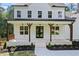 Charming home featuring a covered front porch with wood columns and trim at 10350 Alvin Rd, Johns Creek, GA 30022