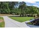 Expansive front yard showcasing a long driveway and meticulously landscaped flowerbeds at 10350 Alvin Rd, Johns Creek, GA 30022