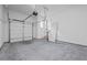 A spacious two car garage with a metal door and a convenient entrance to the house, and cement floor at 10350 Alvin Rd, Johns Creek, GA 30022