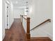 Upstairs hallway with hardwood floors and wooden railing at 10350 Alvin Rd, Johns Creek, GA 30022