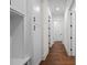 Bright hallway with hardwood floors featuring storage and doors with matte black hardware at 10350 Alvin Rd, Johns Creek, GA 30022