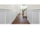 Hallway showcasing hardwood flooring, wainscoting, and staircase at 10350 Alvin Rd, Johns Creek, GA 30022