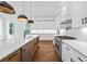 Gourmet kitchen featuring a gas range, stainless steel appliances, wood floors, and white quartz countertops at 10350 Alvin Rd, Johns Creek, GA 30022