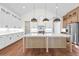 Spacious kitchen with center island, modern lighting, and stainless steel appliances at 10350 Alvin Rd, Johns Creek, GA 30022