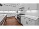 Gourmet kitchen featuring a gas range, stainless steel appliances, wood floors, and white quartz countertops at 10350 Alvin Rd, Johns Creek, GA 30022
