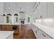 Open kitchen featuring an island with a sink, modern stainless steel appliances, fireplace, and wood floors at 10350 Alvin Rd, Johns Creek, GA 30022