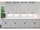 Bright kitchen features white cabinets, quartz countertop, and under-cabinet lighting at 10350 Alvin Rd, Johns Creek, GA 30022