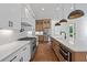 Gourmet kitchen featuring a gas range, stainless steel appliances, wood floors, and white quartz countertops at 10350 Alvin Rd, Johns Creek, GA 30022
