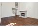 Bright living room with hardwood floors, fireplace, and staircase to upper level at 10350 Alvin Rd, Johns Creek, GA 30022