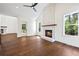 Open living room with brick fireplace, hardwood floors, and lots of natural light at 10350 Alvin Rd, Johns Creek, GA 30022