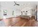 Open living room with view of kitchen, modern lighting, and stainless steel appliances at 10350 Alvin Rd, Johns Creek, GA 30022