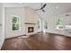 Sun-filled living room featuring a brick fireplace and hardwood floors at 10350 Alvin Rd, Johns Creek, GA 30022