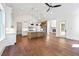 Open concept living room with kitchen view, fireplace, and hardwood floors at 10350 Alvin Rd, Johns Creek, GA 30022