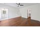 Spacious main bedroom with hardwood floors and a view of a well-lit en-suite bathroom at 10350 Alvin Rd, Johns Creek, GA 30022