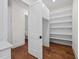 A well-organized pantry with open shelving and a view to a powder room; a convenient layout for any home at 10350 Alvin Rd, Johns Creek, GA 30022
