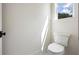 Modern powder room features toilet and a window view at 10350 Alvin Rd, Johns Creek, GA 30022