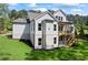 Lovely backyard view of a home with a white brick foundation and stylish deck at 10350 Alvin Rd, Johns Creek, GA 30022