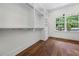 Bright walk-in closet with custom shelves, drawers, hanging racks and hardwood floors at 10350 Alvin Rd, Johns Creek, GA 30022