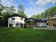 A shot of the backyard featuring an updated patio and freshly cut lawn at 2400 Glenrock Dr, Decatur, GA 30032